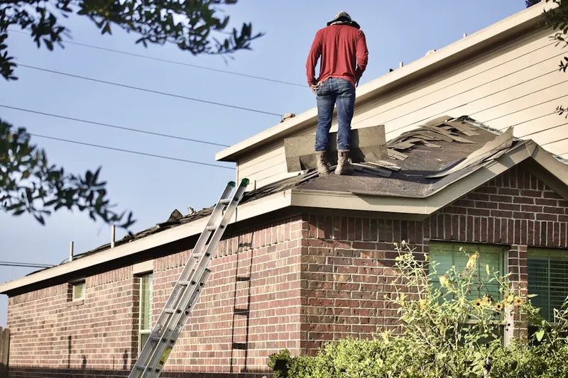 Professional roofer working on a residential roof in Culver-West